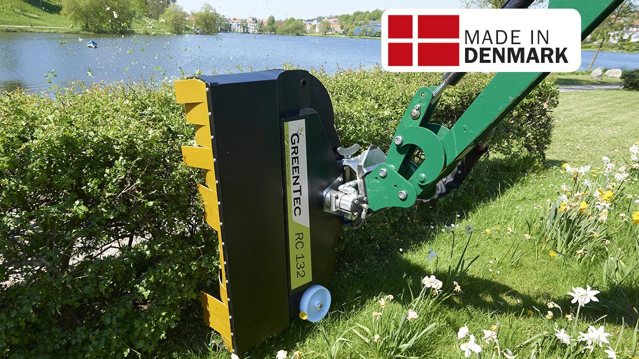 Žlutý drtič větví GreenTec ořezává a drtí živý plot Žlutý drtič větví GreenTec ořezává a drtí živý plot